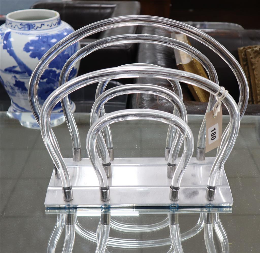 A 1970s lucite magazine stand, width 38cm, depth 23cm, height 31cm